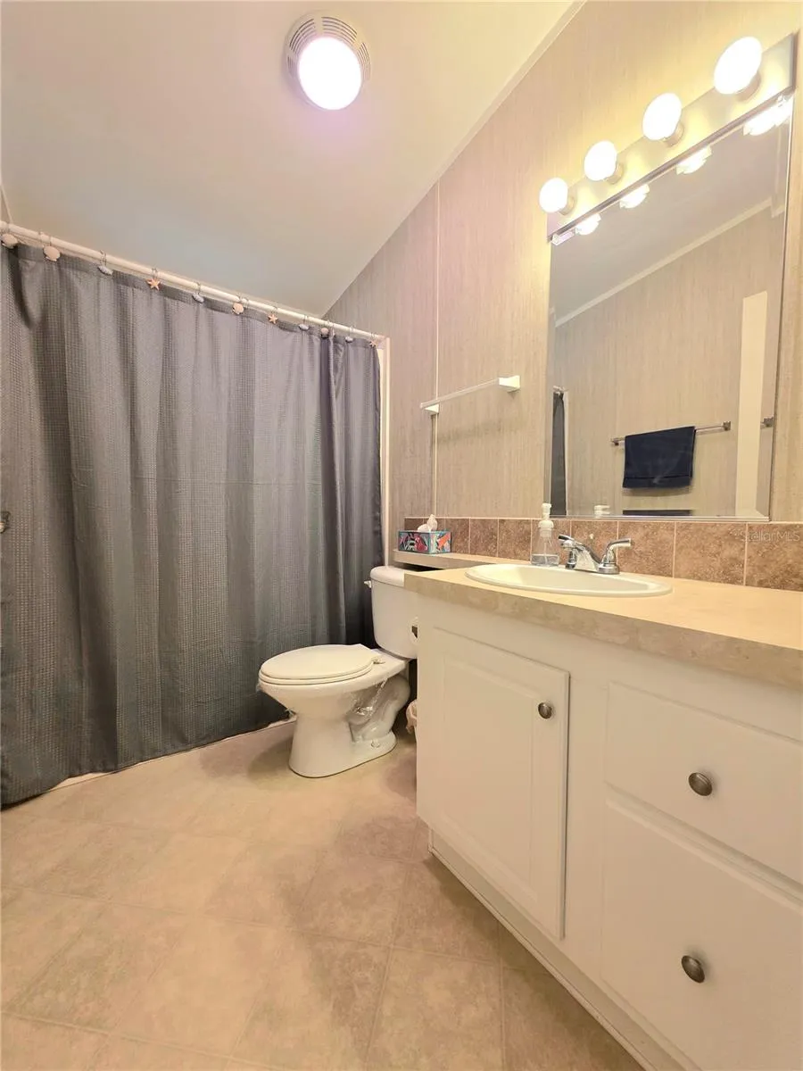 Primary bathroom features a bathtub with shower surround.