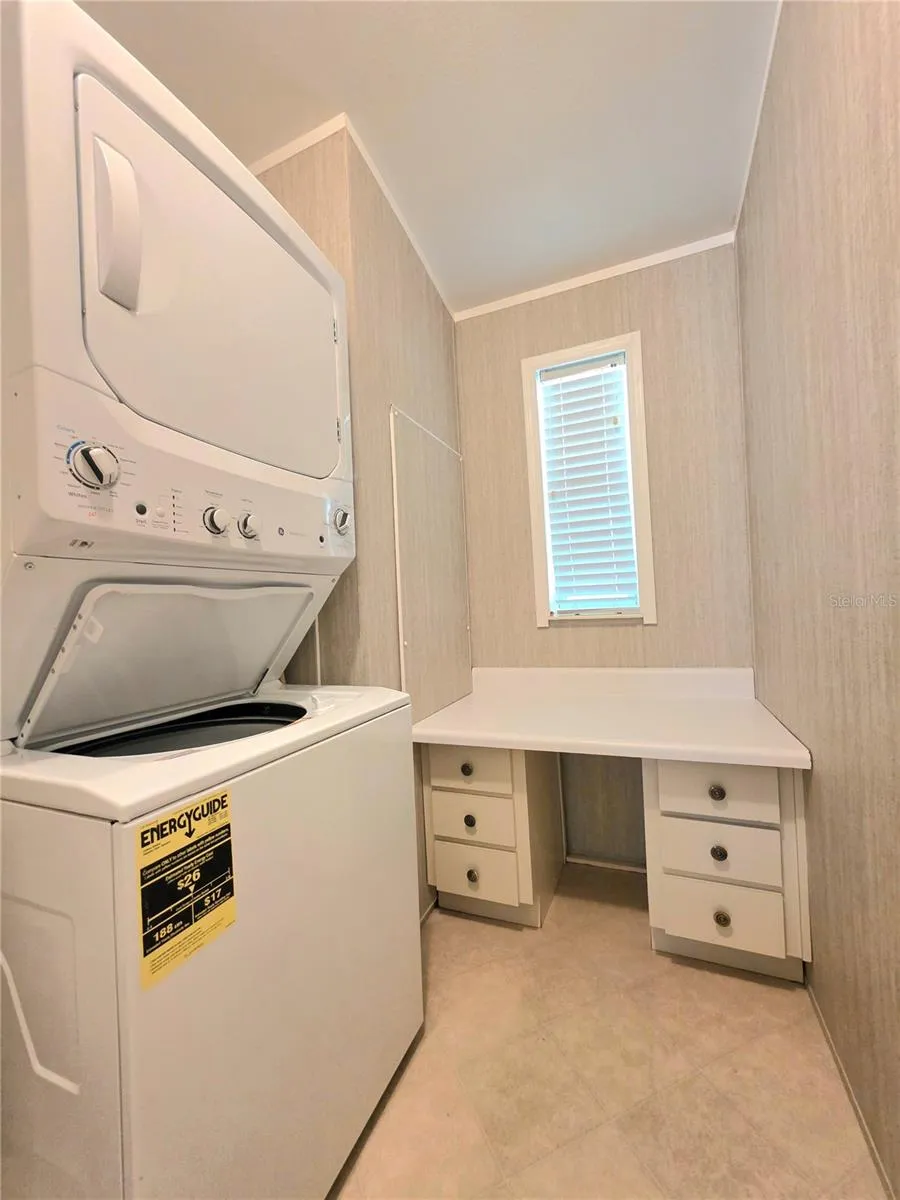 Stack washer/dryer &amp; folding table with drawers.