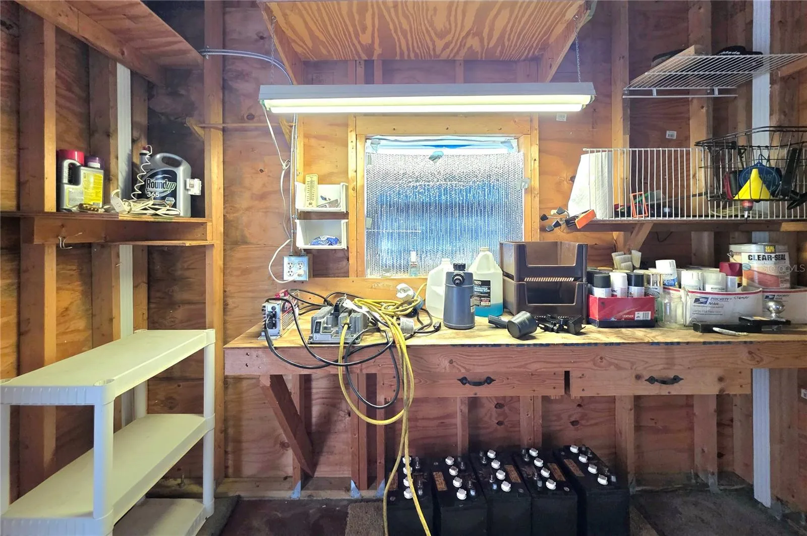 Attached golf cart garage with electric opener, work bench &amp; shelving.