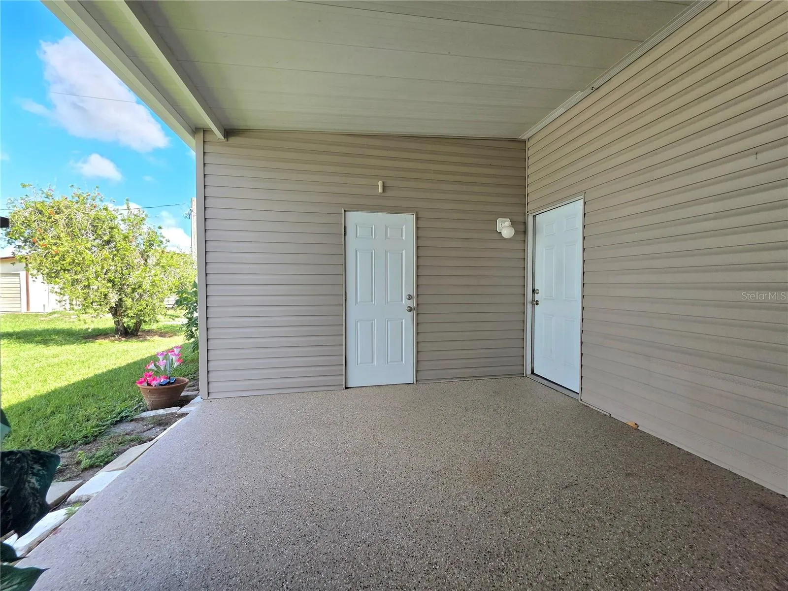 Carport. Door to attached 1car garage to the right. door to attached golf cart garage to the left.