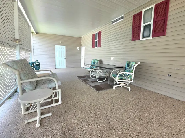Carport seating area &amp; attached golfcart/one car garage.