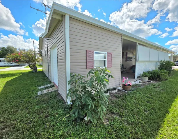 West side &amp; back of home with attached golf cart garage.