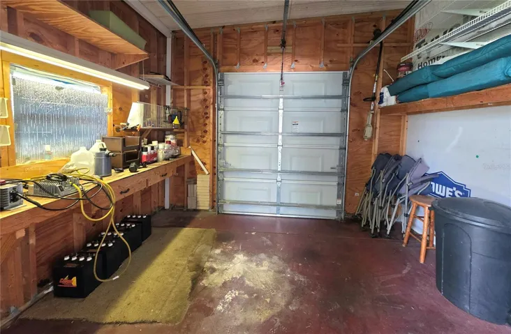 Attached golf cart garage with electric opener, work bench &amp; shelving.