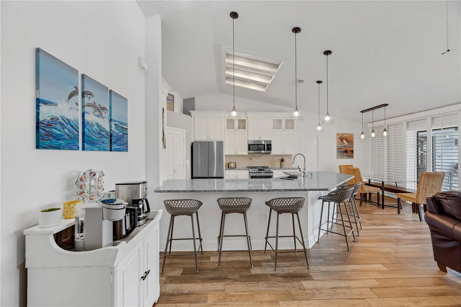 Cathedral ceilings and wood-plank-look tile flooring provide a stylish, durable finish throughout the entire home with no carpet.