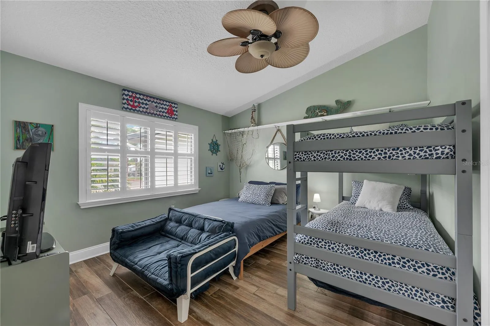 Bedroom #4 on the front of this home is set up as a bunk room and has cathedral ceiling and lots of natural light pouring in.