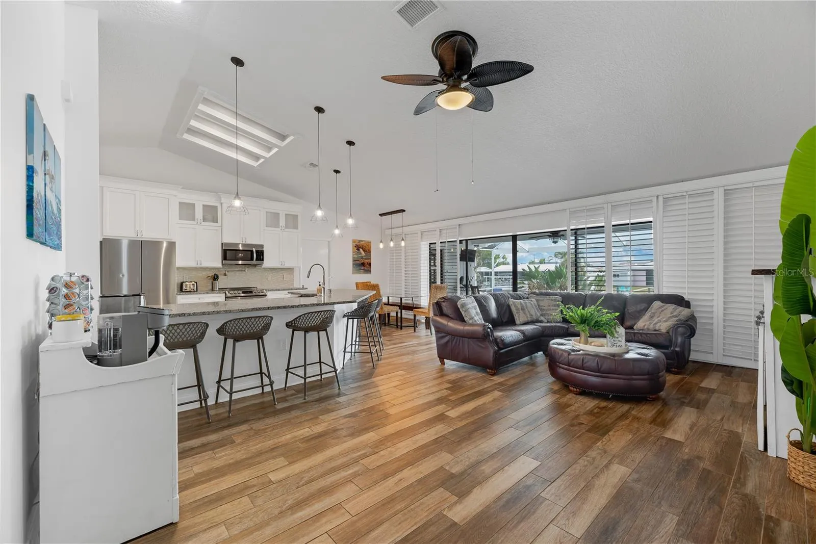 Open-concept floor plan where 12-foot sliding glass doors open to the expansive outdoor living area and beautiful waterfront views.