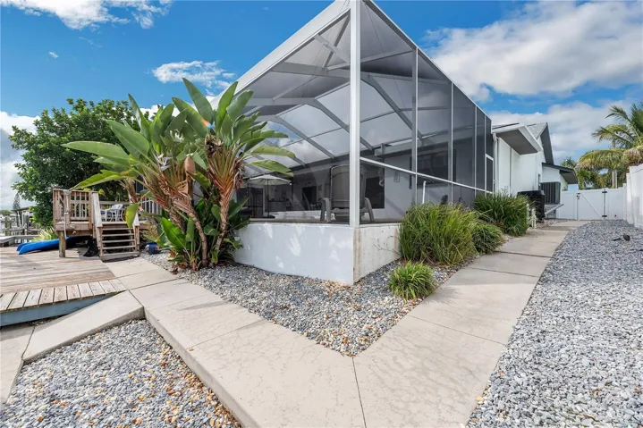 The lot is completely fenced with PVC fencing and there is a walkway on both sides with a low maintenace landscape design hard scape.