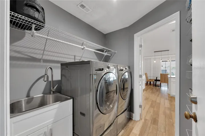 There is a convenient utility sink inside the laundry room.