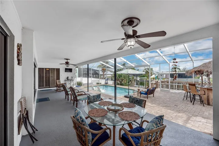 The spacious covered area provides plenty of shade and protection from Florida’s sun and passing showers, making outdoor enjoyment comfortable year-round.