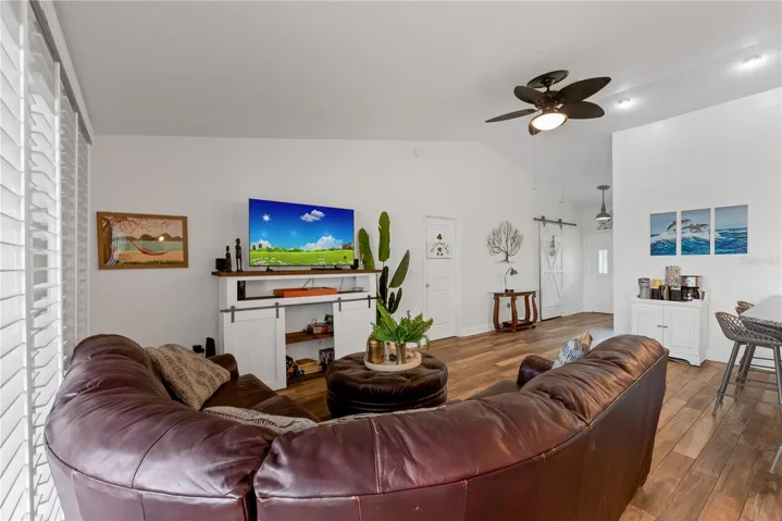 The door to the Owner's suite is off the Living room and the sliding barn door in the foyer conceals a coat closet and additional storage.