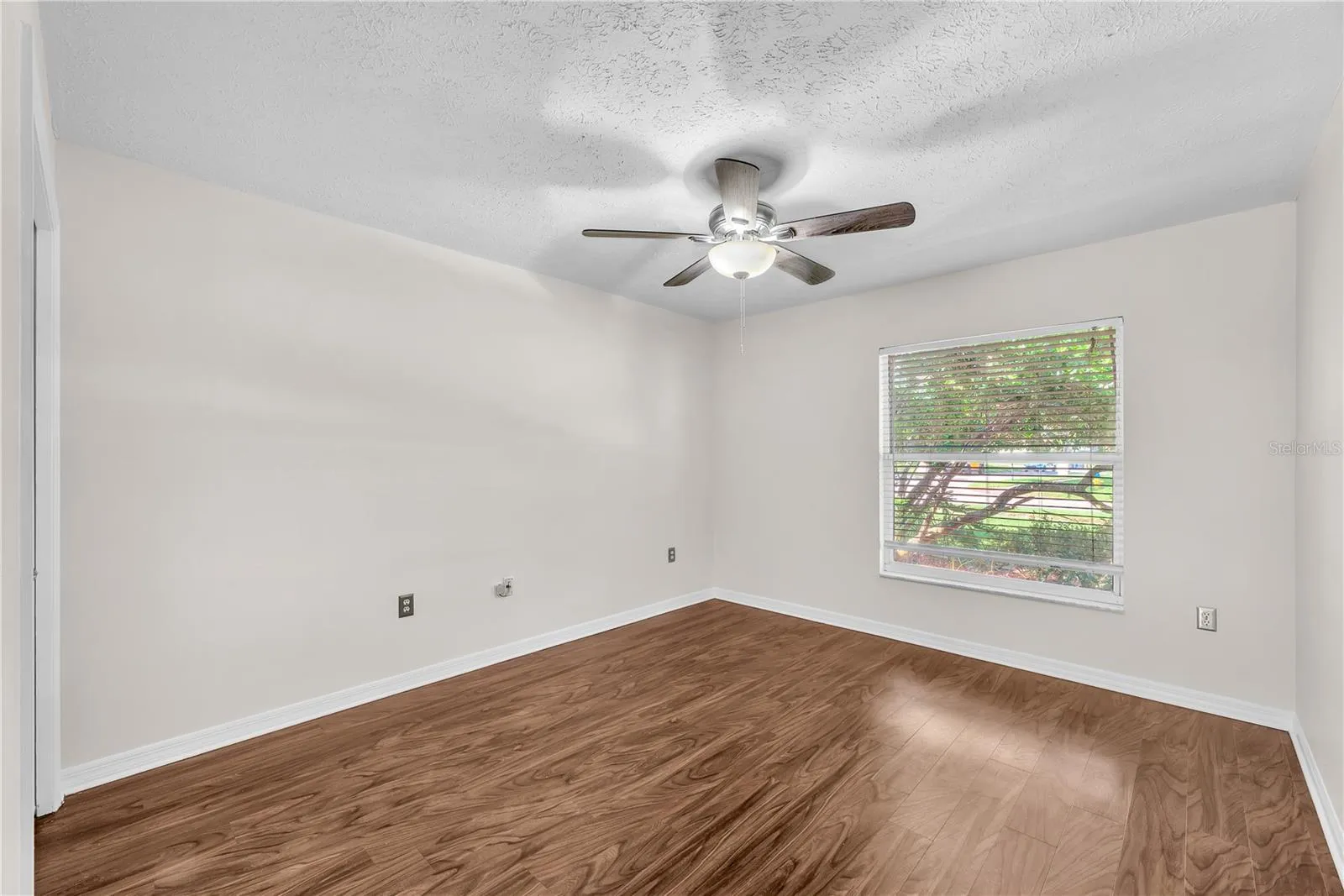 Bedroom #4 located to the right of the foyer has a built-in closet and would make a perfect office space with the double french door entry.