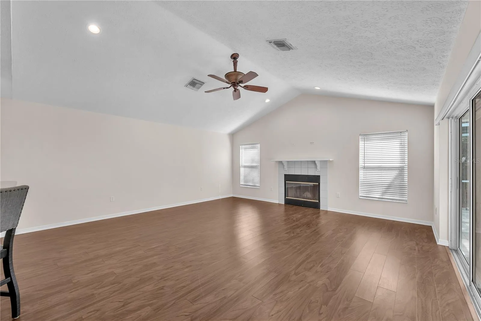 The inviting family room centers around a fireplace, creating a warm and comfortable gathering space.