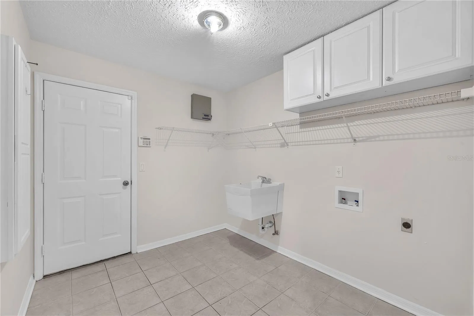 A spacious laundry room with a convenient utility sink adds functionality to everyday living.
