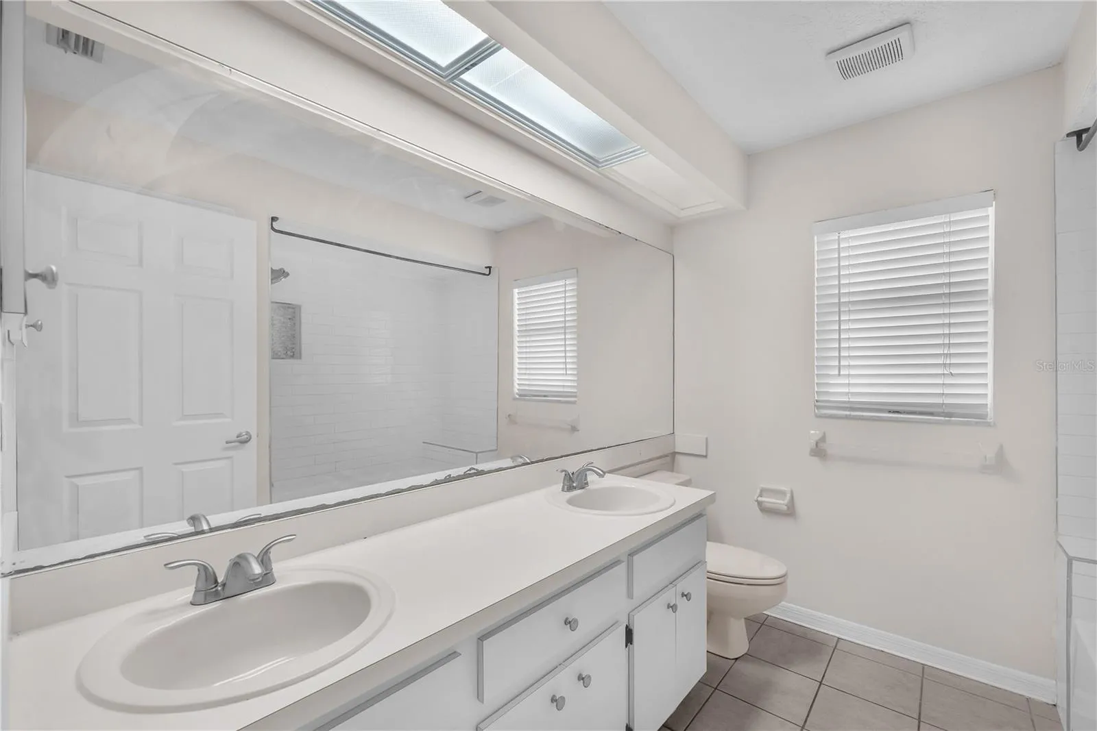 Full bathroom that is shared by the secondary bedrooms has dual sinks and a tub/shower combination.