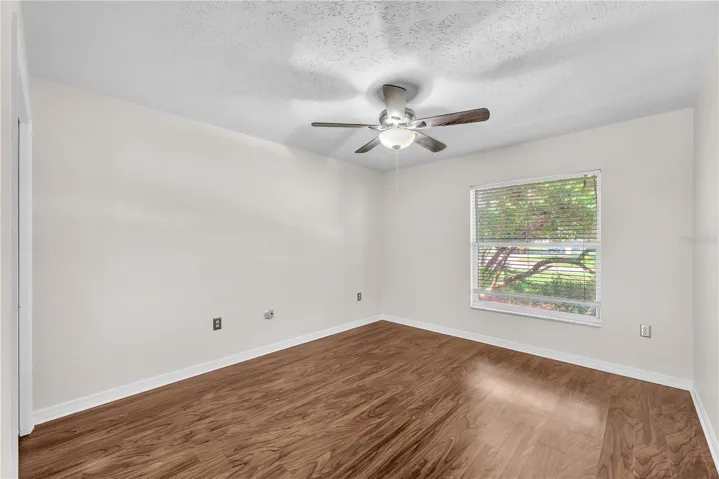 Bedroom #4 located to the right of the foyer has a built-in closet and would make a perfect office space with the double french door entry.
