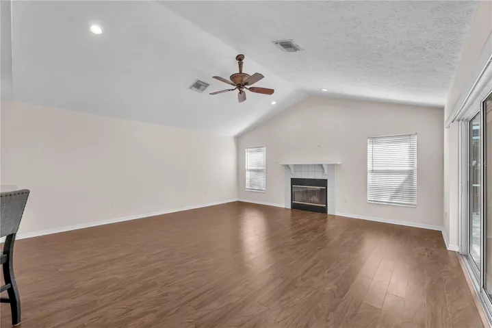 The inviting family room centers around a fireplace, creating a warm and comfortable gathering space.
