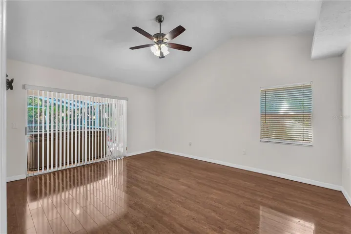 The spacious Primary Suite is tucked away on one side of the home and features two walk-in closets, Vaulted ceilings, private access to the screened lanai, and an ensuite bath.