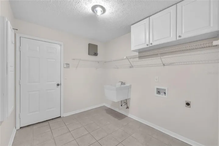 A spacious laundry room with a convenient utility sink adds functionality to everyday living.