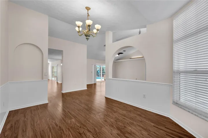 The arched architectural detail is beautifully echoed by a matching arched niche in the dining room, creating a balanced and cohesive design element.