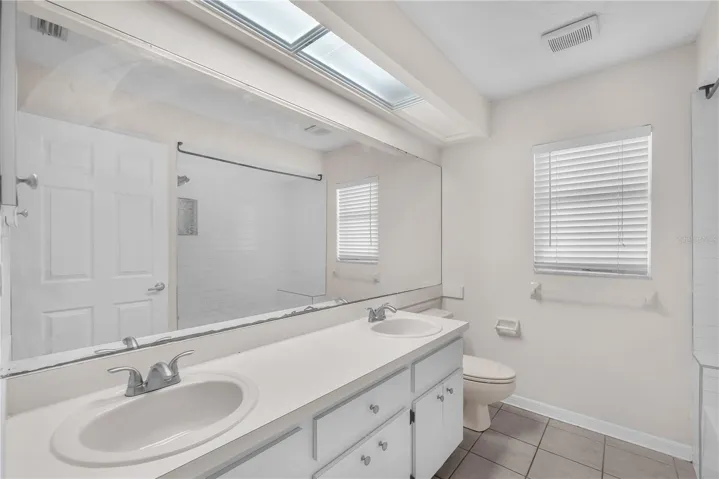 Full bathroom that is shared by the secondary bedrooms has dual sinks and a tub/shower combination.