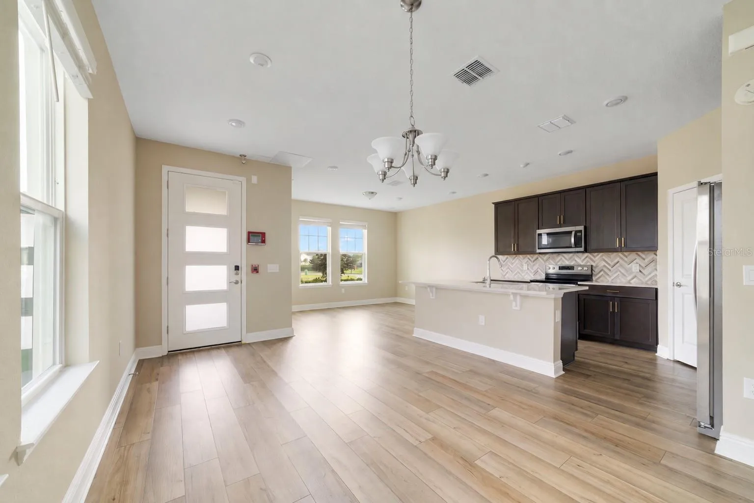 LUXURY VINYL PLANK FLOORING runs throughout the main living areas, creating a stylish and cohesive look while offering easy everyday maintenance.