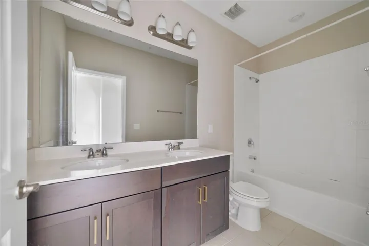 A well-positioned second full bathroom provides easy access for the three additional bedrooms.