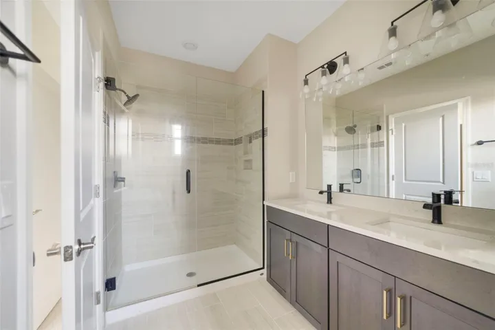 The Primary Bath offers DUAL SINKS, A STEP-IN SHOWER, and a PRIVATE WATER CLOSET.