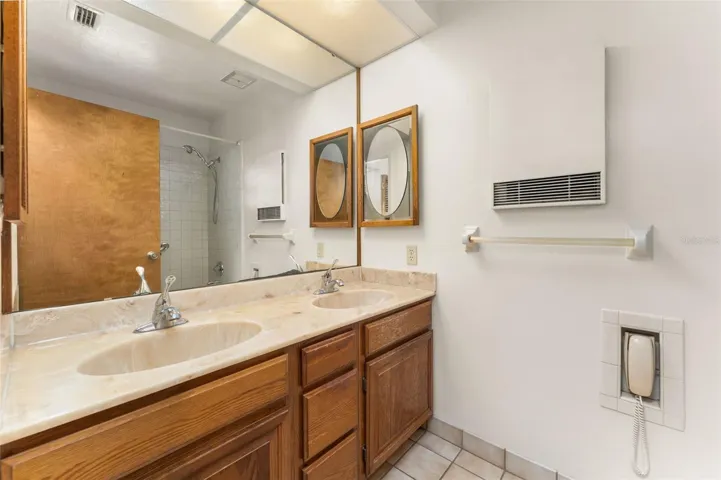 Primary bathroom with dual sinks and tub/shower