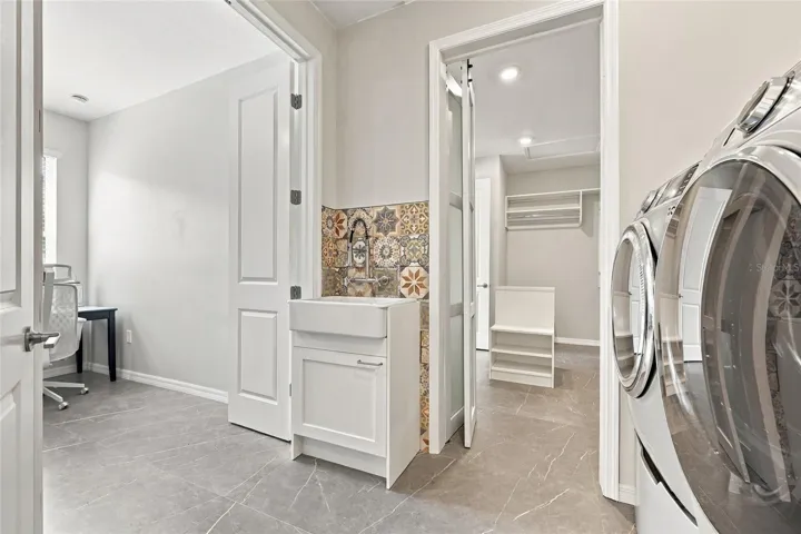 Laundry Room with entrances pathway to Bedroom 2, Walk-in Closet and Hall.