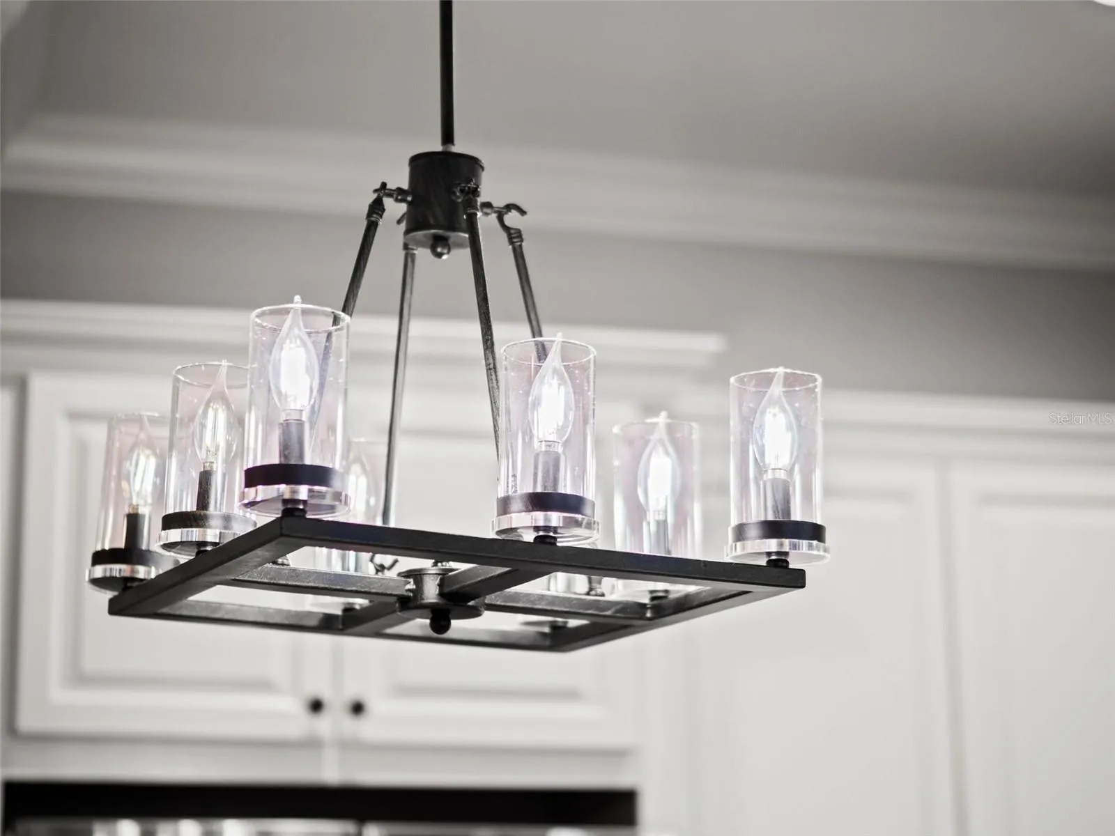 Wrought iron light fixture about kitchen island