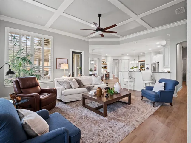 Den/great room with gorgeous view of back patio, golf course, lake, and horse pastures