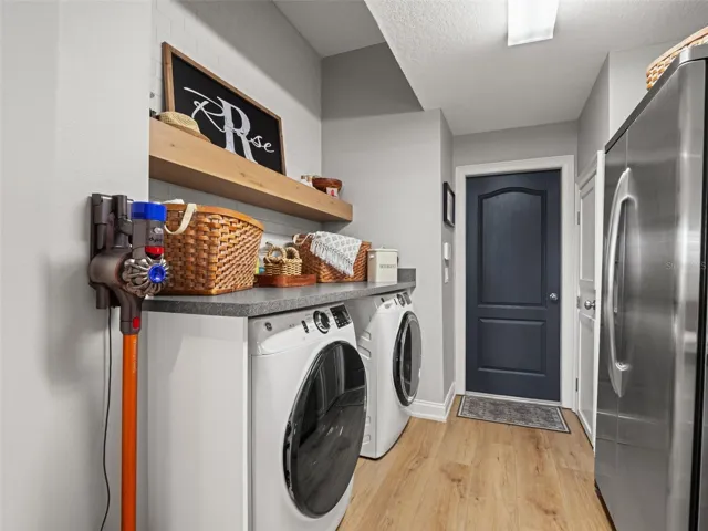 Barn doors lead to the laundry room with built in folding area