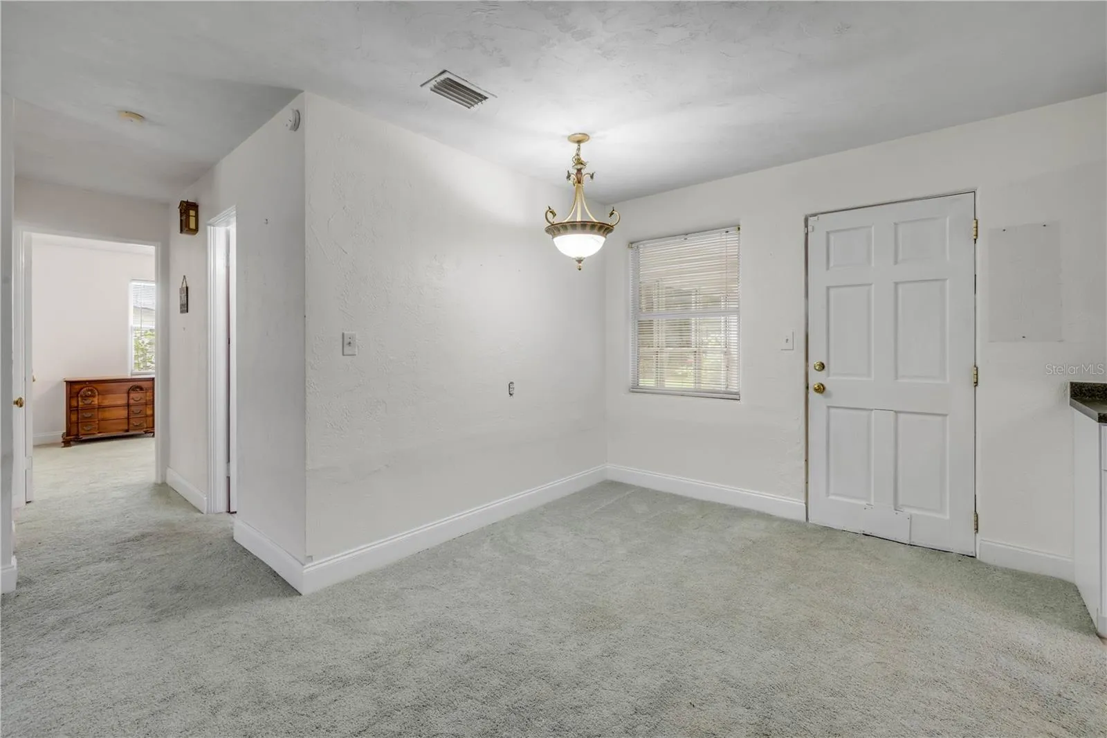 Front entry room looking AT rear door that leads to bonus porch/Florida room