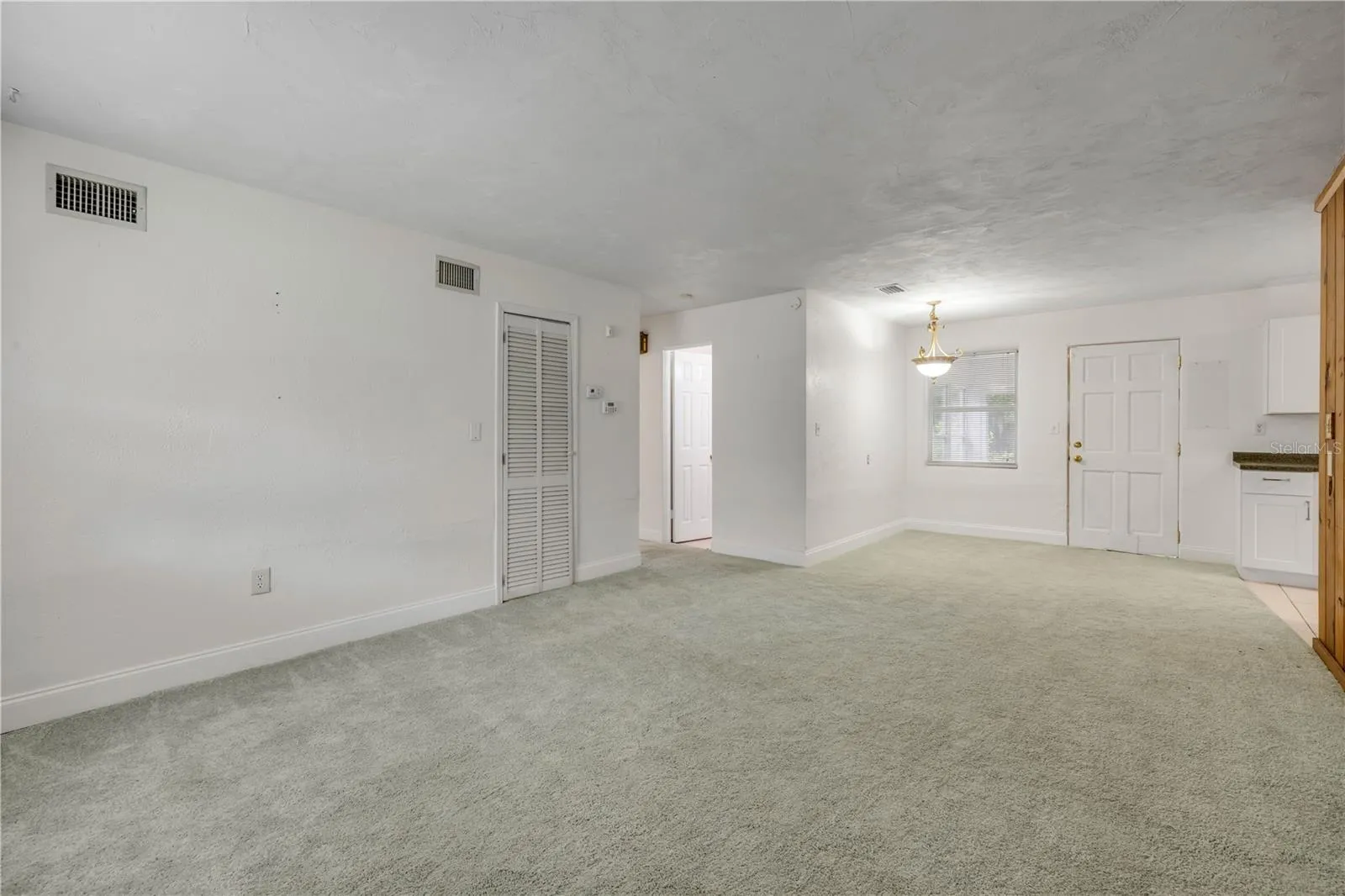 Front entry room looking AT rear door that leads to bonus porch/Florida room