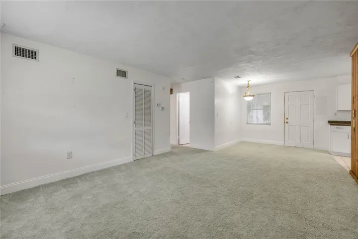 Front entry room looking AT rear door that leads to bonus porch/Florida room