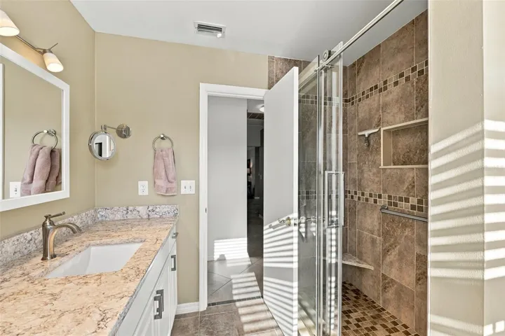 Guest bathroom has shower but no tub.