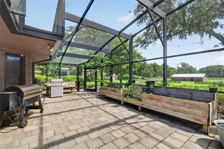 screened lanai by pool / herb garden / grilling area