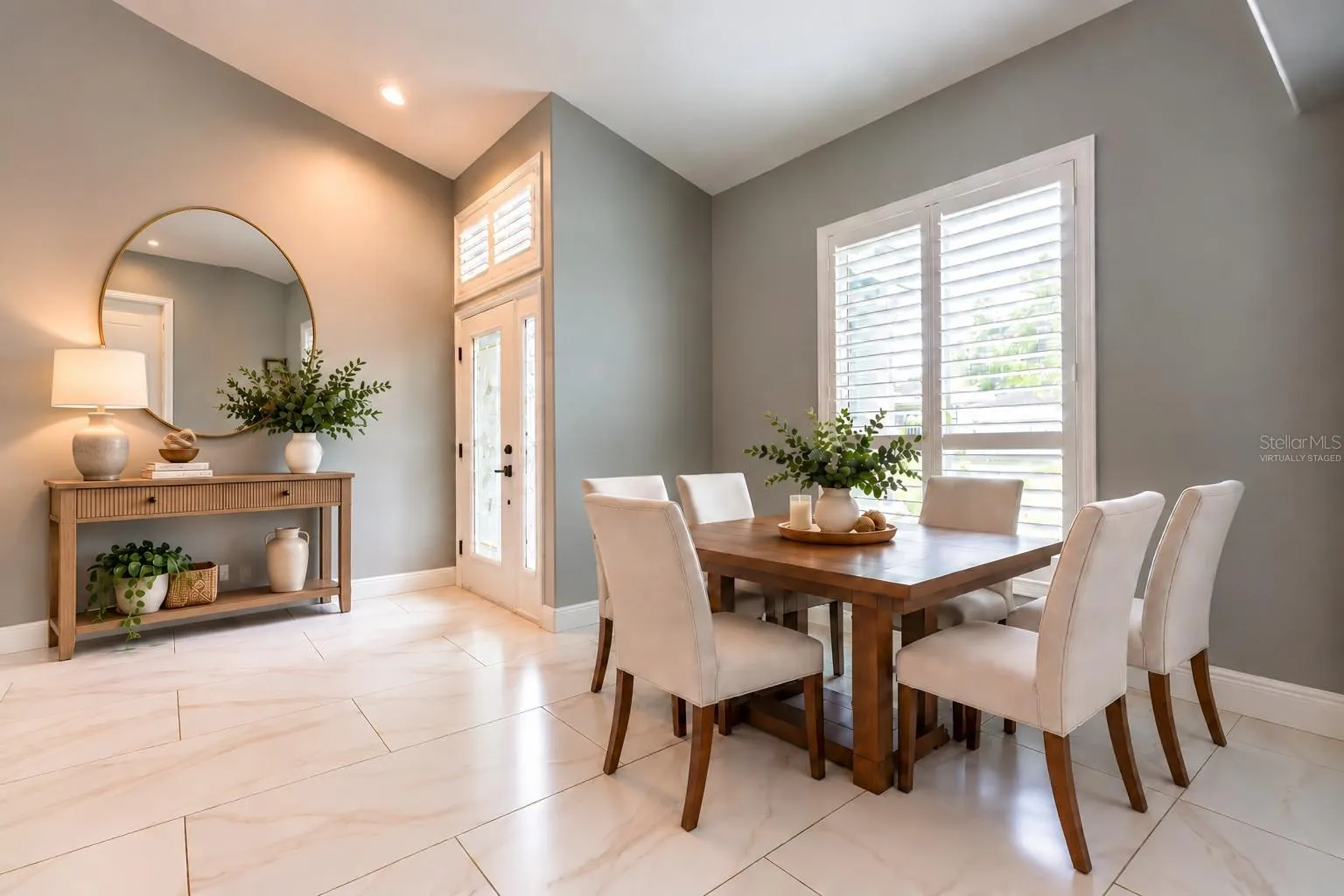 Virtually staged entrance and dining area.