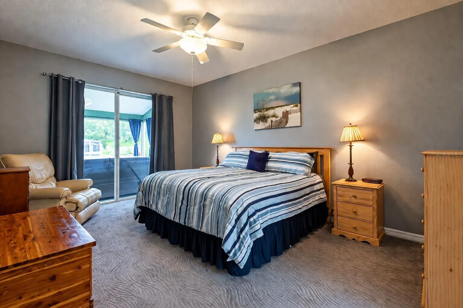 Primary bedroom with sliders to the lanai and hot tub.