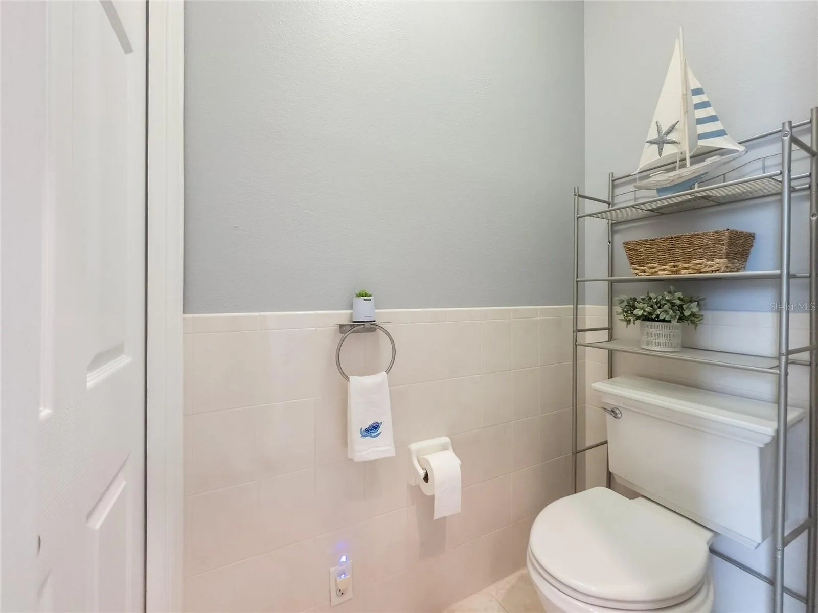 Water closet with linen closet.