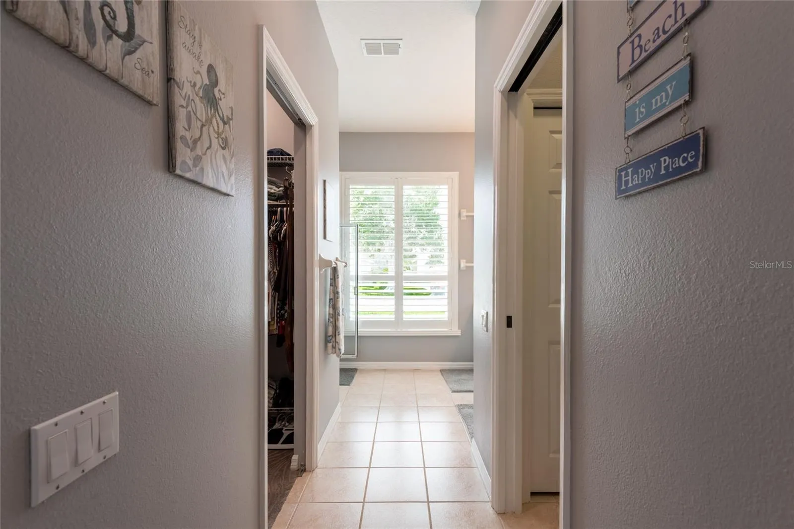 Hall to water closet, walk-in closet, sinks and shower.