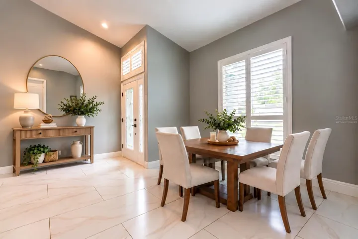 Virtually staged entrance and dining area.