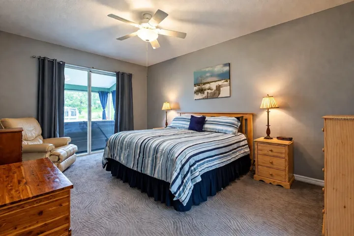 Primary bedroom with sliders to the lanai and hot tub.
