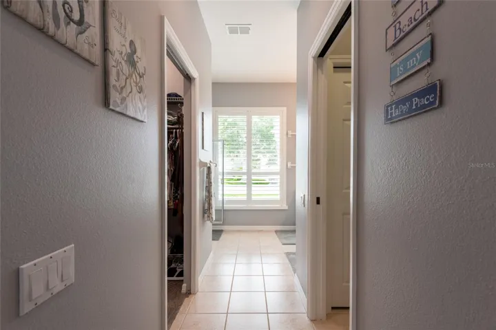Hall to water closet, walk-in closet, sinks and shower.
