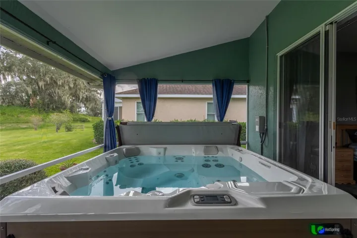 Located off the primary bedroom is a 2-year-old hot tub with curtains to close for privacy.