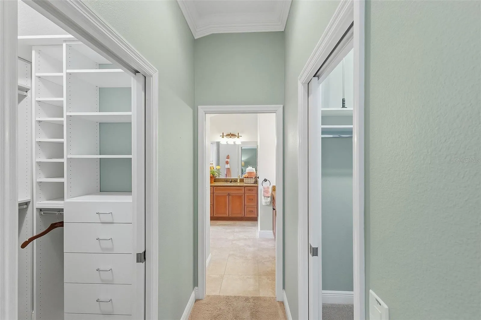 hallway to primary bathroom - double walk-on closets