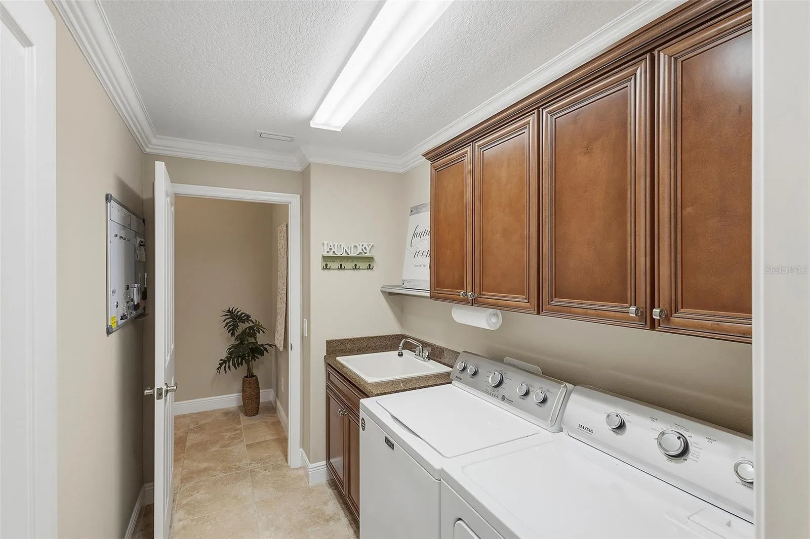 laundry room with utility sink and storage