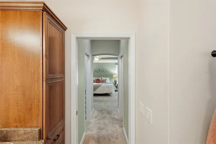 hallway to primary bedroom from bathroom
