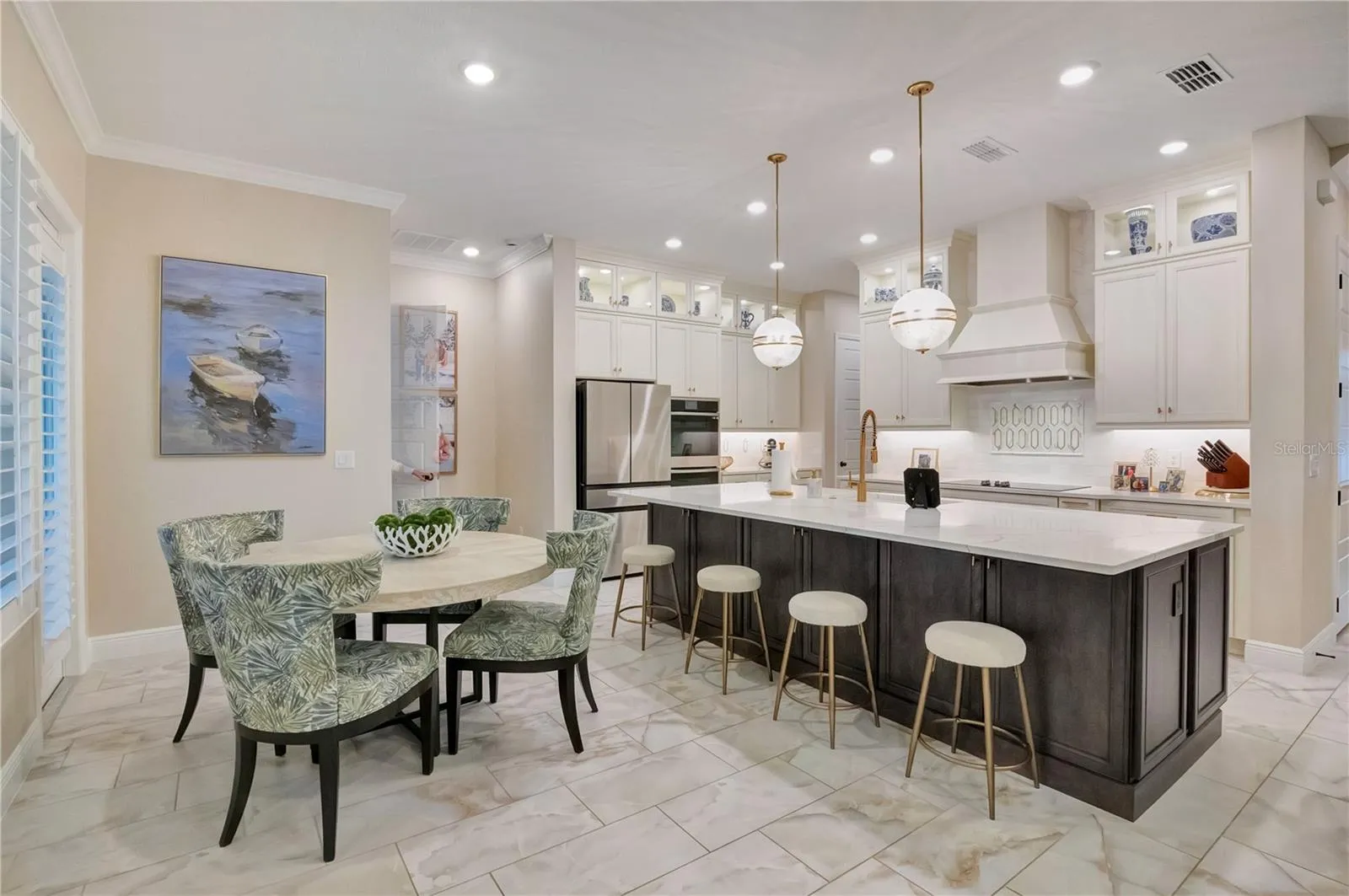 Spacious kitchen and breakfast area featuring upgraded tile flooring, crown molding and recessed lighting.
