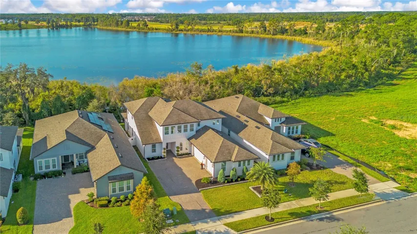 Lake views framed by mature trees and natural landscaping along the backyard.